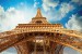 Wall murals Eiffel tower view from below background clouds