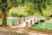 Wallpapers mural beautiful view of a tropical park with a lake and a bridge